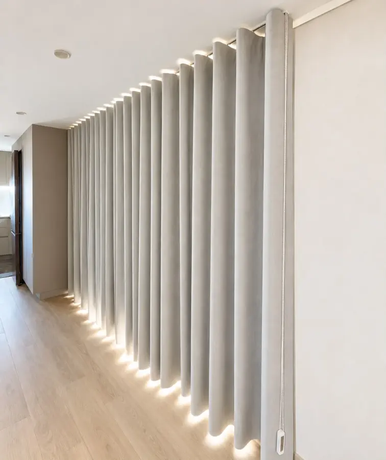 Cortina de onda cinzenta ao longo de um corredor, com luz indireta no chão